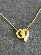 Collier pendentif Givenchy logo G authentifié — Le Comptoir Vintage